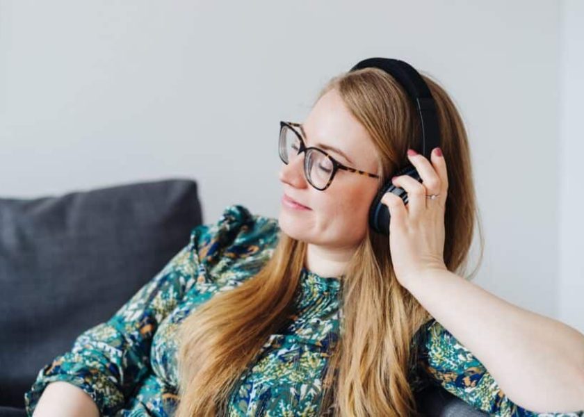 Young woman daydreaming while listening to music