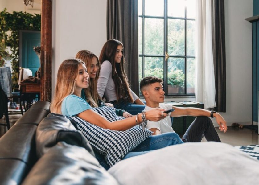four-friends-watching-tv-at-home-picture-id1351046908-1044×587