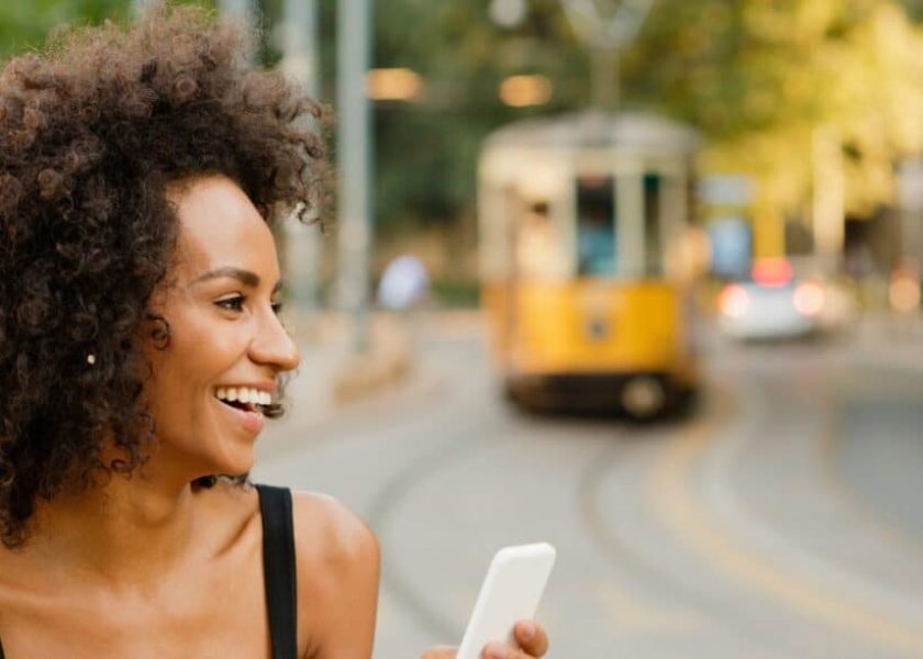 happy-woman-using-mobile-phone-picture-id578833216-1044×587