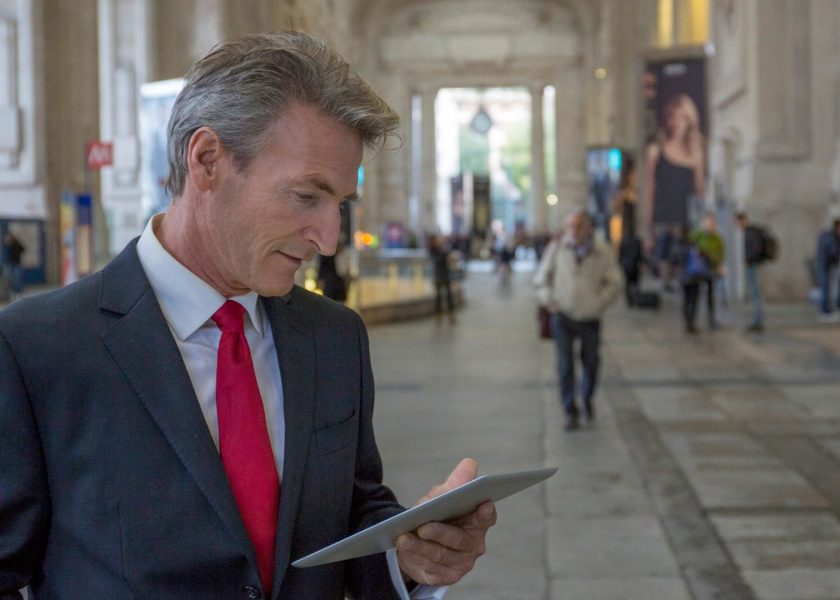 businessman-uses-digital-tablet-in-train-station-picture-id1303172047-1920×1080